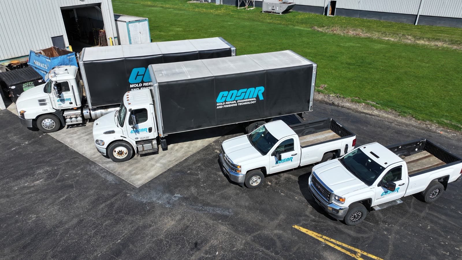 Aerial view of a branded company truck fleet