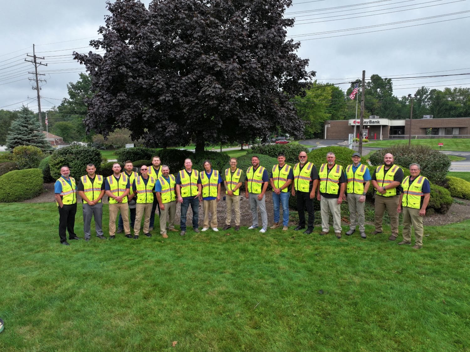 Aerial team portrait of a field crew in safety vests